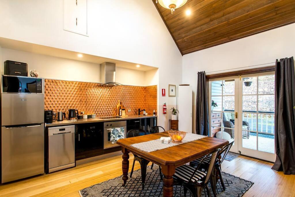 a kitchen with a wooden table in a room at Convent Franklin - Martina Unit in Franklin