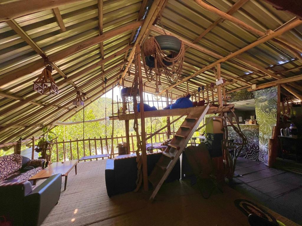 a room with a loft bed in a tent at Noname Hostel And Cafe in Ella