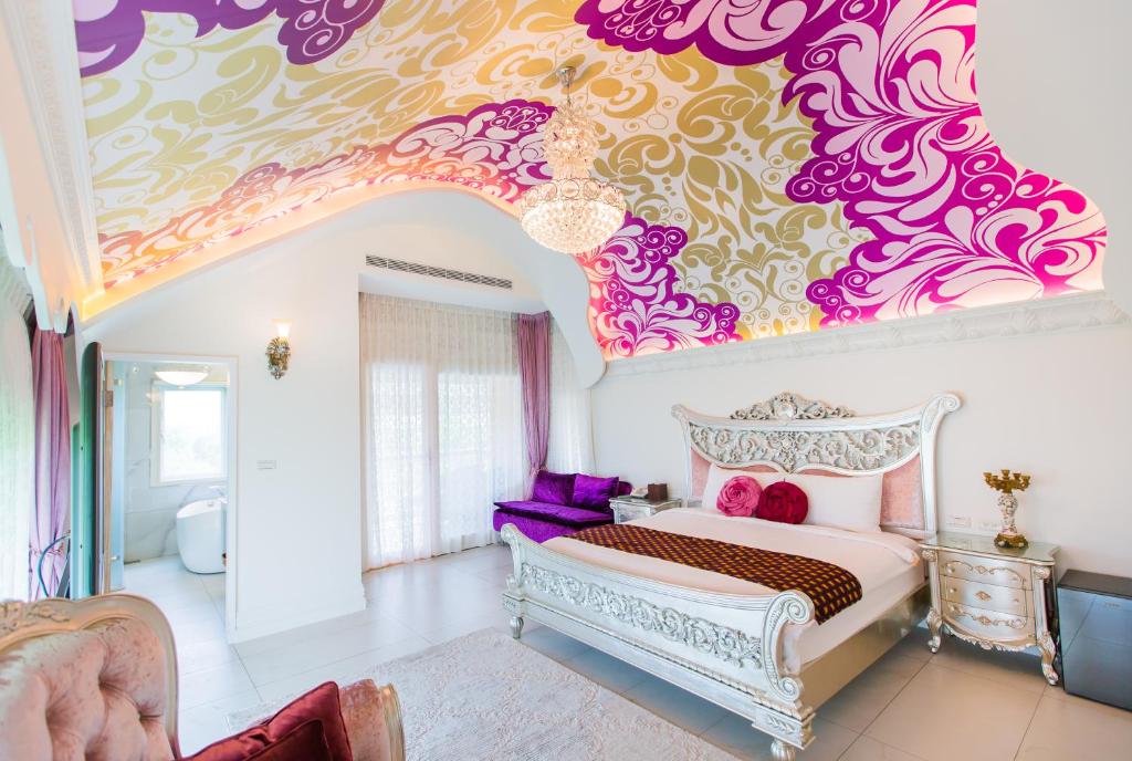 a bedroom with a bed and a colorful ceiling at Jane Castle in Wujie