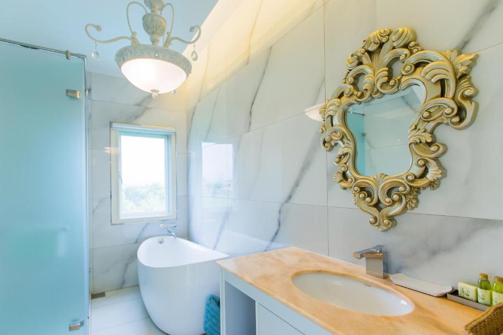 a bathroom with a sink and a mirror on the wall at Jane Castle in Wujie