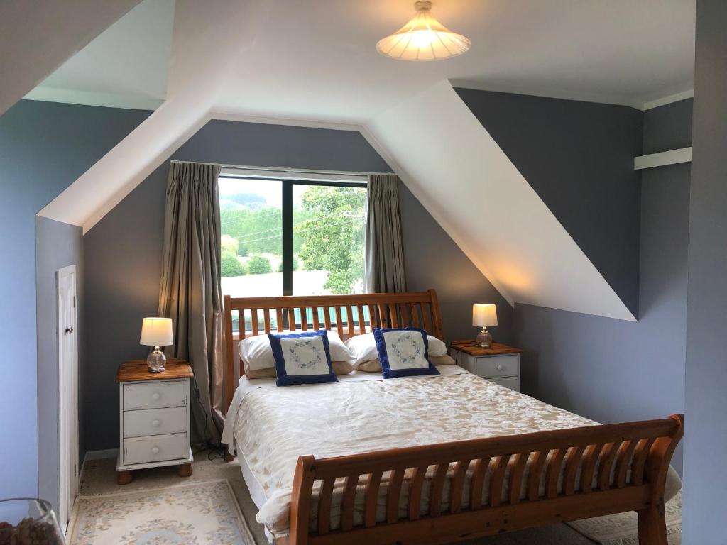 a bedroom with a bed with two pillows on it at Hunua Ranges in Hunua