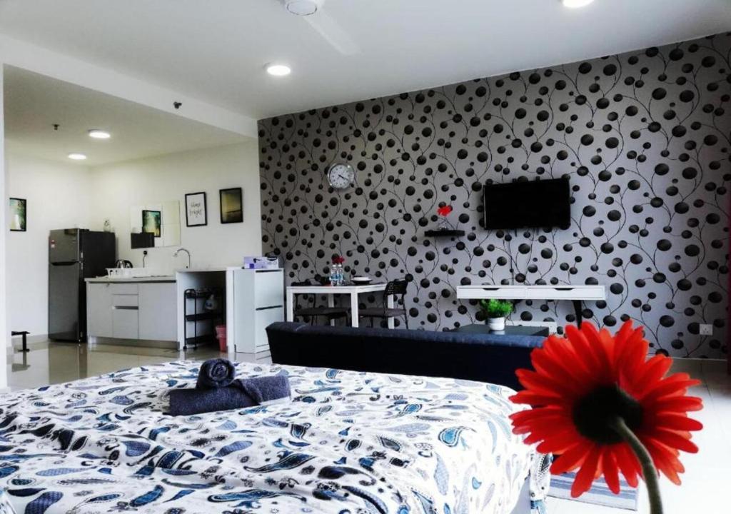 a living room with a bed and a wall with a flower at Peanut Butter Homestay #Trefoil Setia City in Setia Alam