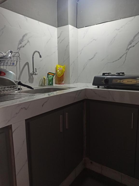 a kitchen with a sink and a counter top at Ganjar Homestay in Sentool