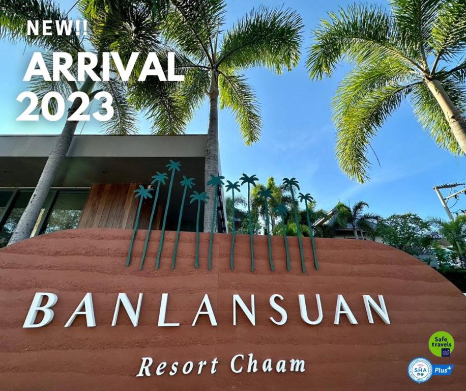 een bord voor een gebouw met palmbomen bij Banlansuan Resort SHA Plus in Cha Am