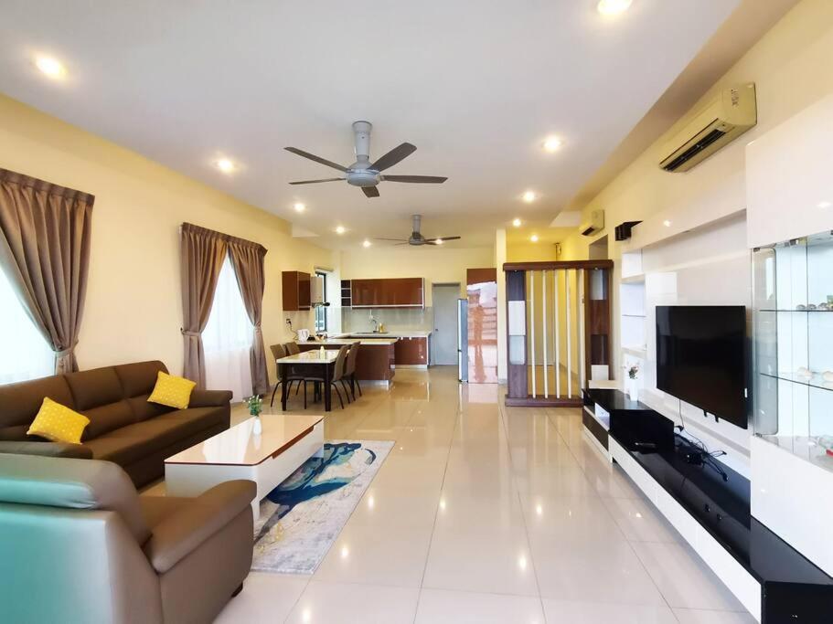 a living room with a couch and a flat screen tv at Deluxe Sunrise Suite 3 bedroom 2000sqft Condo Loft B side seaview above Imago Shopping Mall in Kota Kinabalu