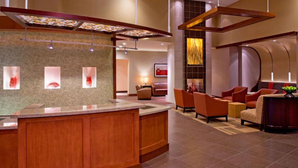 a lobby of a hospital with chairs and a waiting room at Sonesta Select Austin North Central in Austin