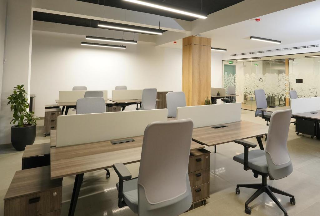an office with desks and chairs in a room at Loft Hotel Apartment in Addis Ababa