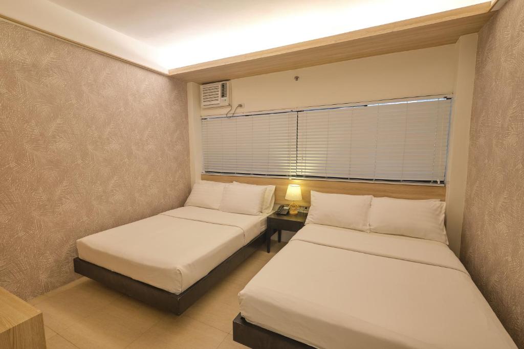 Postel nebo postele na pokoji v ubytování The Tides Hotel Boracay