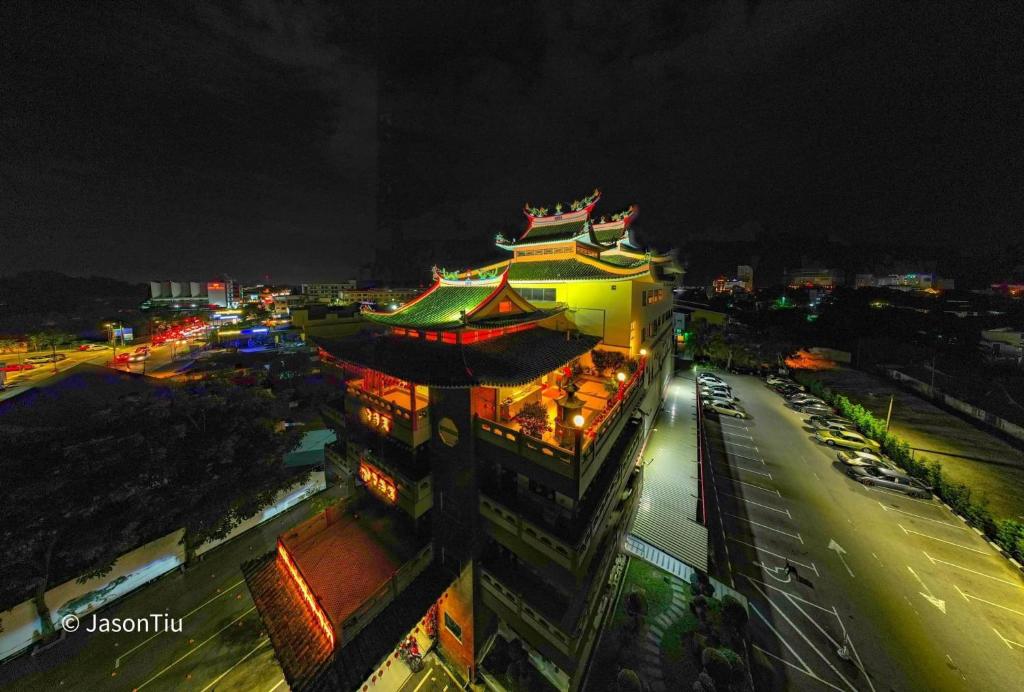 a large building with a chinese roof at night at Heng Ann Guest House in Malacca
