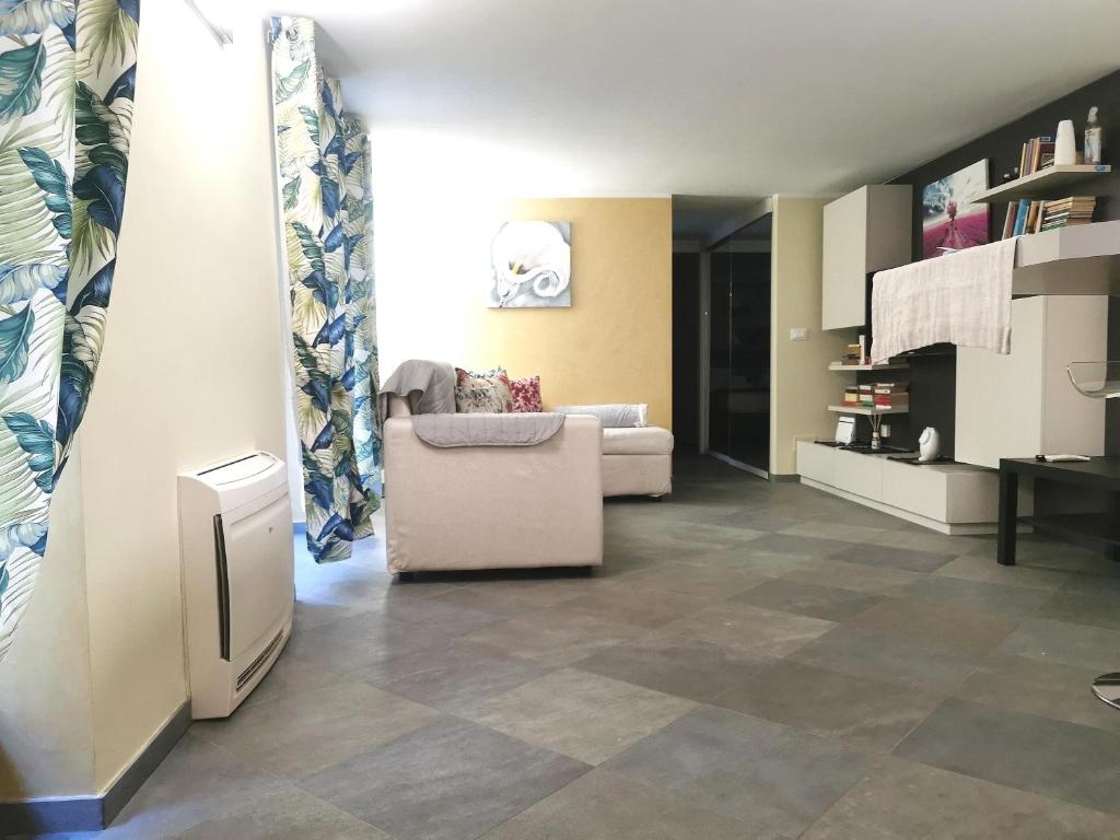 a living room with a couch and tile floor at TORINO VACANCY 4 - Bridge House in Turin