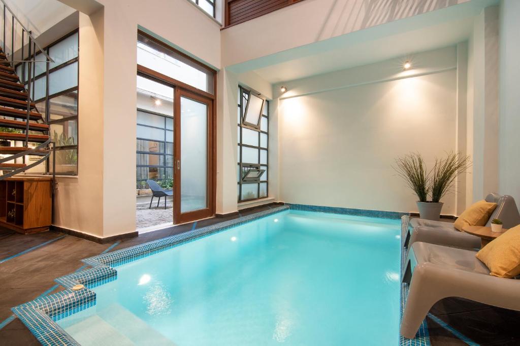 a swimming pool in a house with a living room at Villa Meliti in Athens