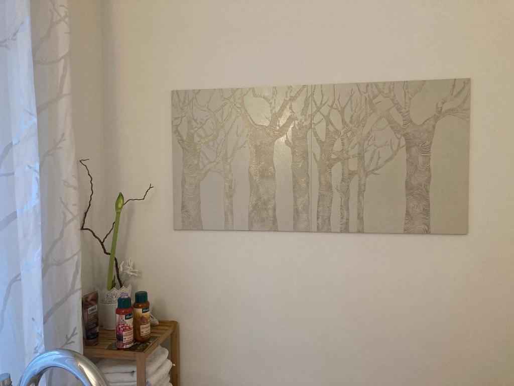 a painting of trees on a white wall at Auszeit am Haffufer in Wilhelmshof