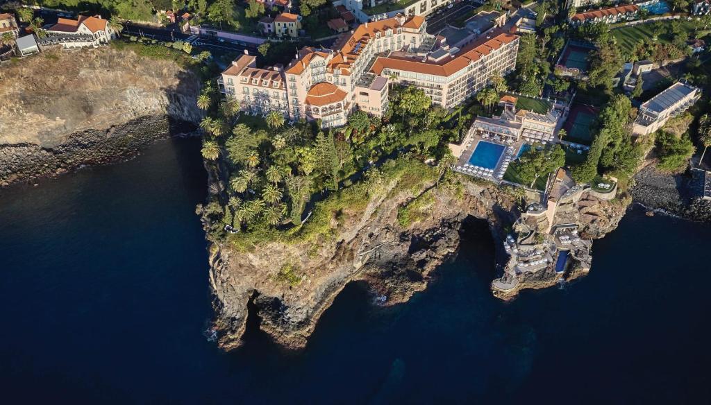 an aerial view of a house on an island in the water at Reid's Palace, A Belmond Hotel, Madeira in Funchal