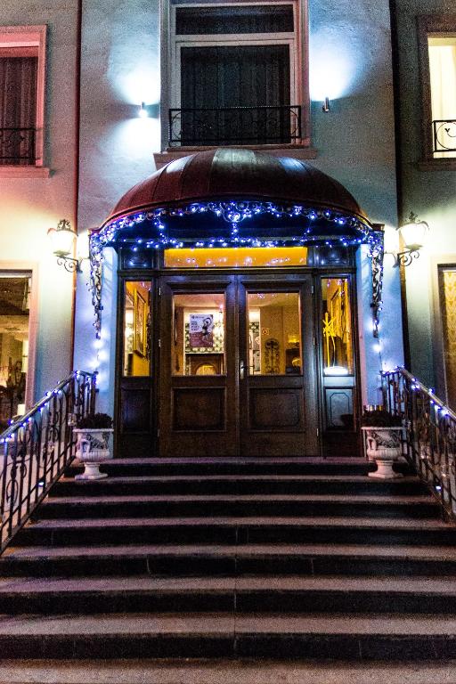 a set of stairs leading to a building with blue lights at Villa Cuprum in Lubin