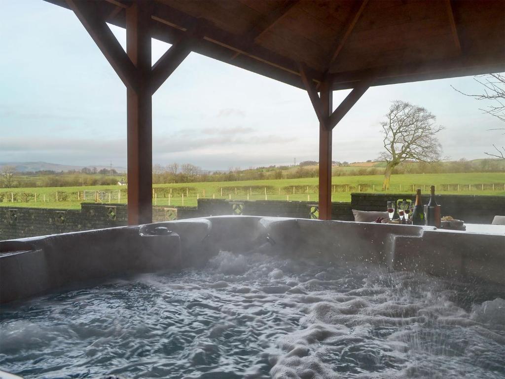a large hot tub with water in it at Hillview in Beith