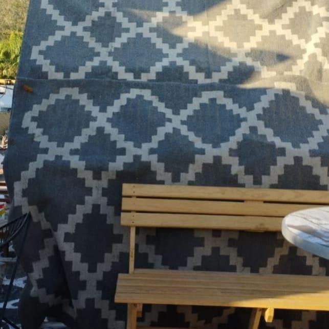 a bench sitting in front of a wall with a blanket at Condominio Bugambilias, Penthouse, Rooftop, Cinema, Teepe, vistas a la Montaña in Guadalajara