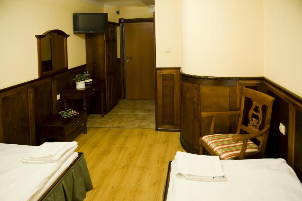 Łóżko lub łóżka w pokoju w obiekcie Hotel Kresowianka