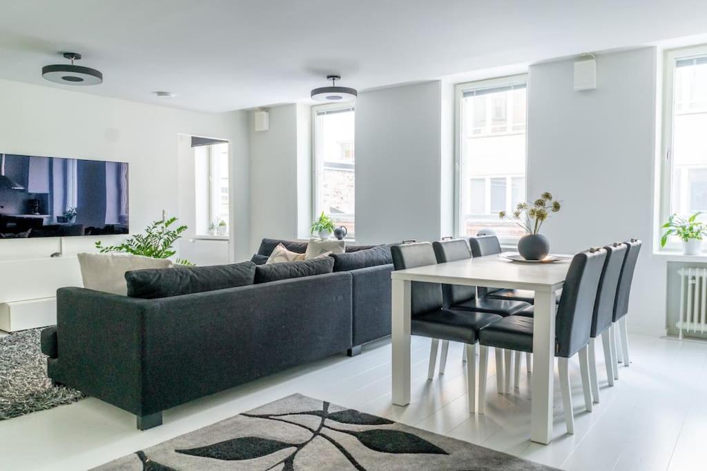 a living room with a couch and a table at Spacious 1 BR with a central location in Helsinki