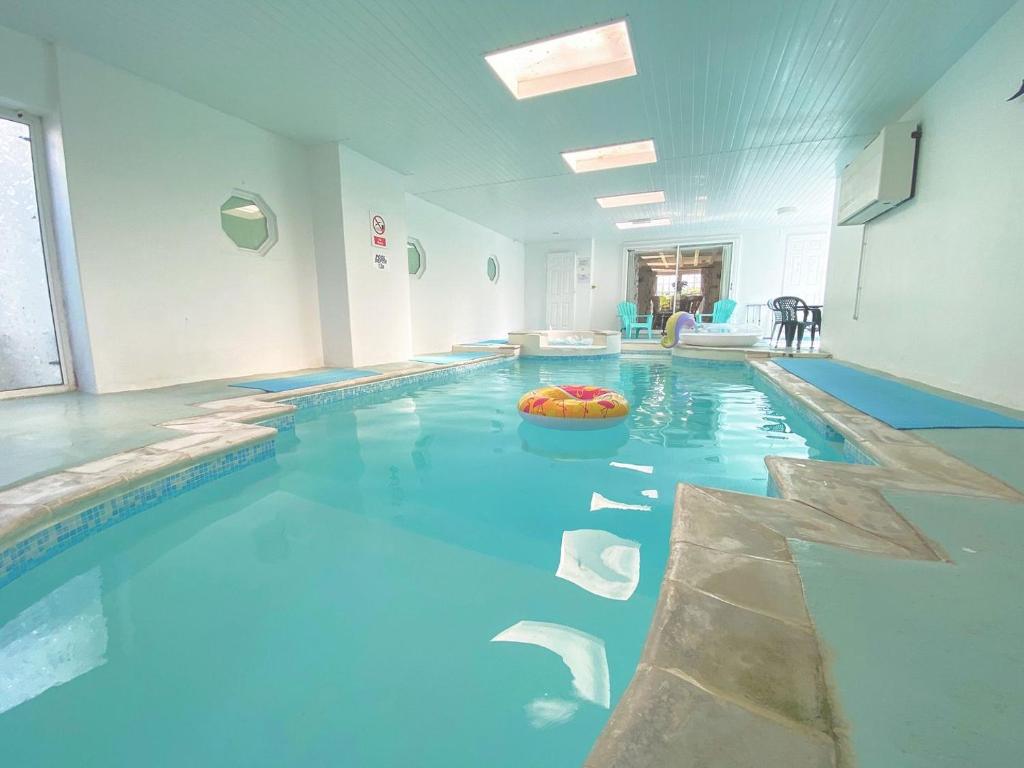 a large swimming pool with a ball in the middle at Holemoor Cottage in Bridgerule