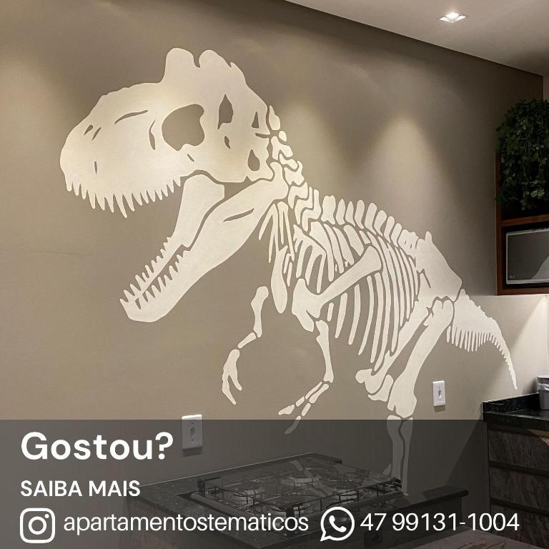 a skeleton of a dinosaur on a wall at Apto temático Dinossauros in Pomerode