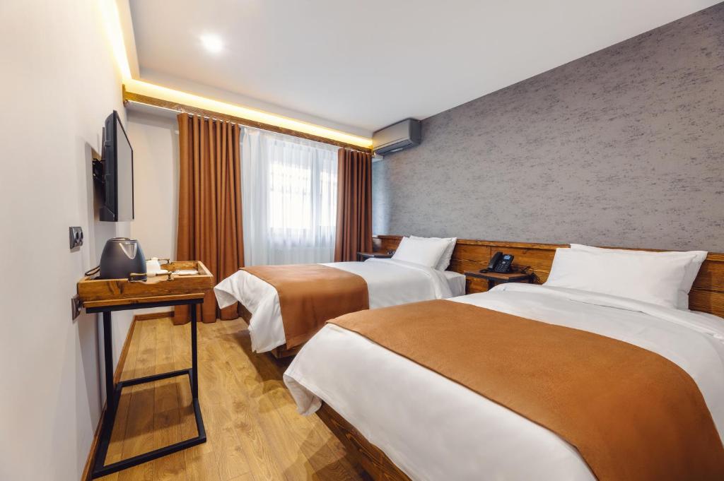 Postel nebo postele na pokoji v ubytování Ivy Hotel