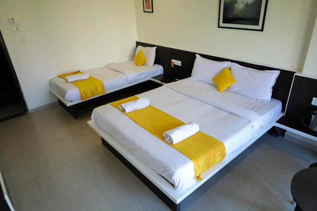 Postel nebo postele na pokoji v ubytování Hotel Sai Bansi