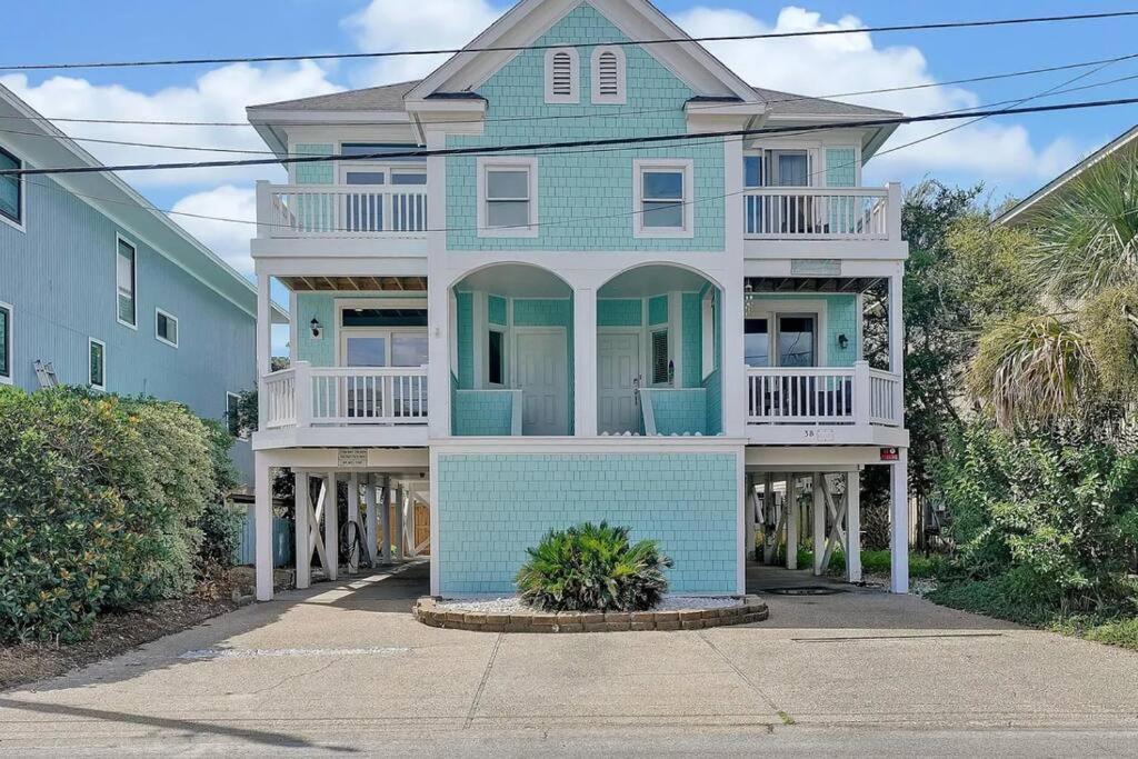 a blue and white house with stilts at Henderson Haven 4 BR / 3 BA Villa, Steps to Beach in Wrightsville Beach