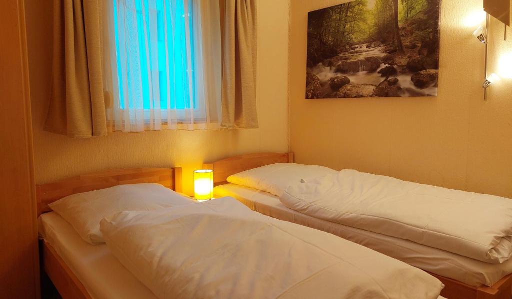 Postel nebo postele na pokoji v ubytování Bungalowpark Zinglingsberg by Rujana
