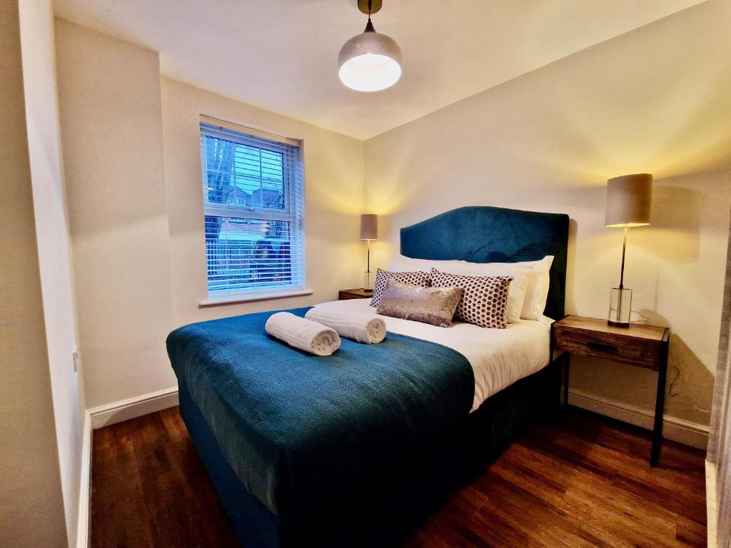 a bedroom with a bed with two pillows on it at Stylish Luxury Serviced Apartment next to City Centre with Free Parking - Contractors & Relocators in Coventry