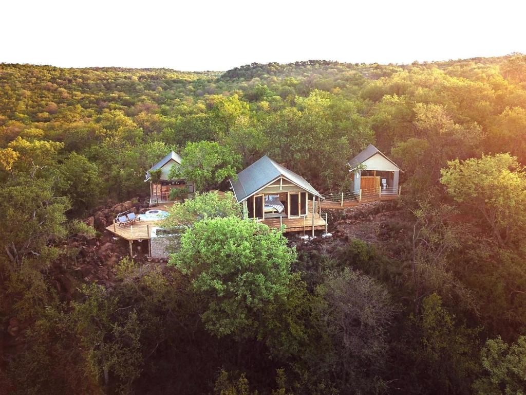 an aerial view of two cottages in a forest at Bushveld Bivouac Private Camp in Mica