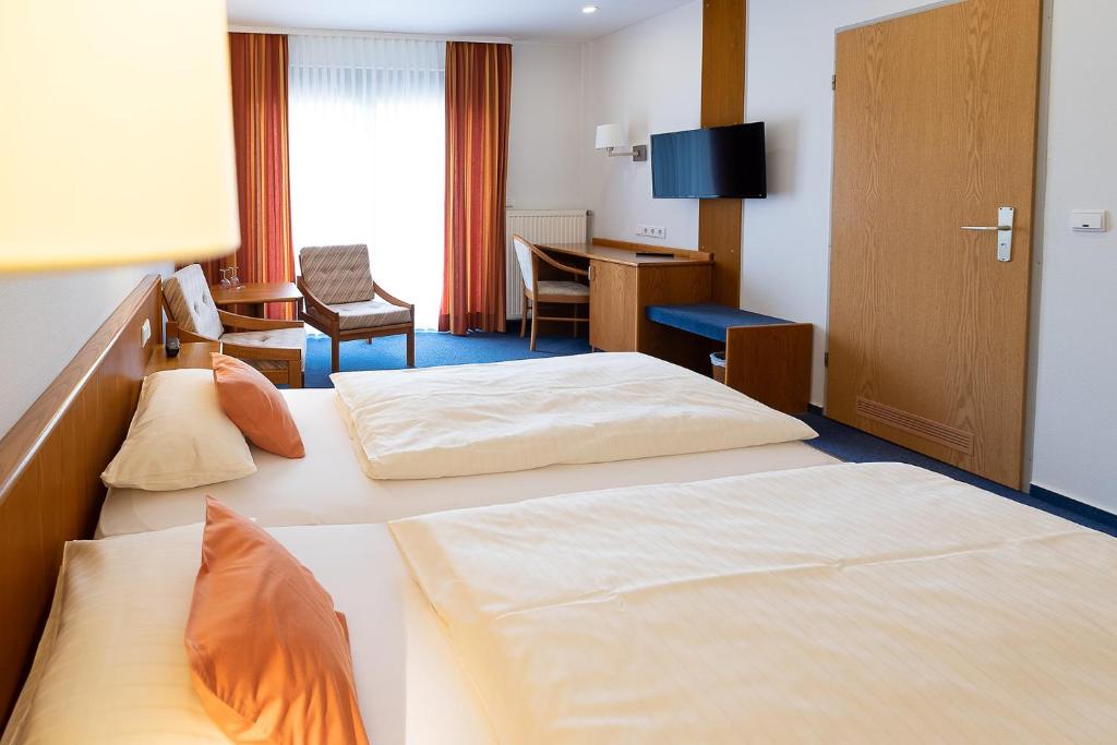 Postel nebo postele na pokoji v ubytování Hotel Am Steinberg