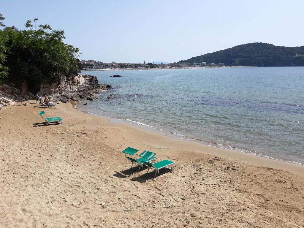 2 Stühle und ein Picknicktisch am Strand in der Unterkunft Un letto a Gaeta - Villa a Fontania in Gaeta