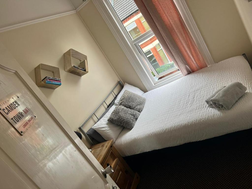 a small bedroom with a bed and a window at Room in family home near Penny Lane Liverpool in Liverpool