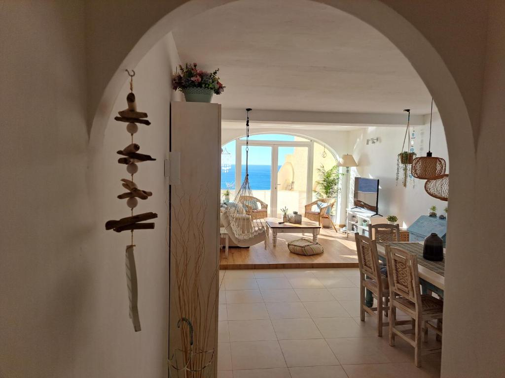a kitchen and dining room with a view of the ocean at la ventana al mar in Jávea