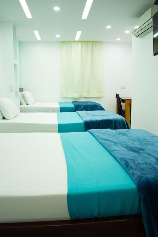 Postel nebo postele na pokoji v ubytování Hotel Brisas De Calima