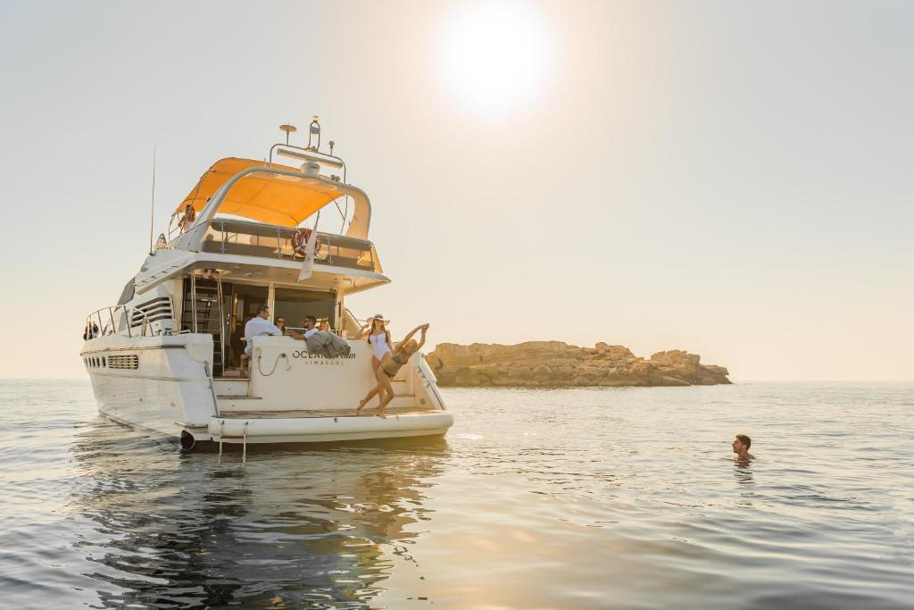 a group of people on a boat in the water at Cap St Georges Villas in Peyia