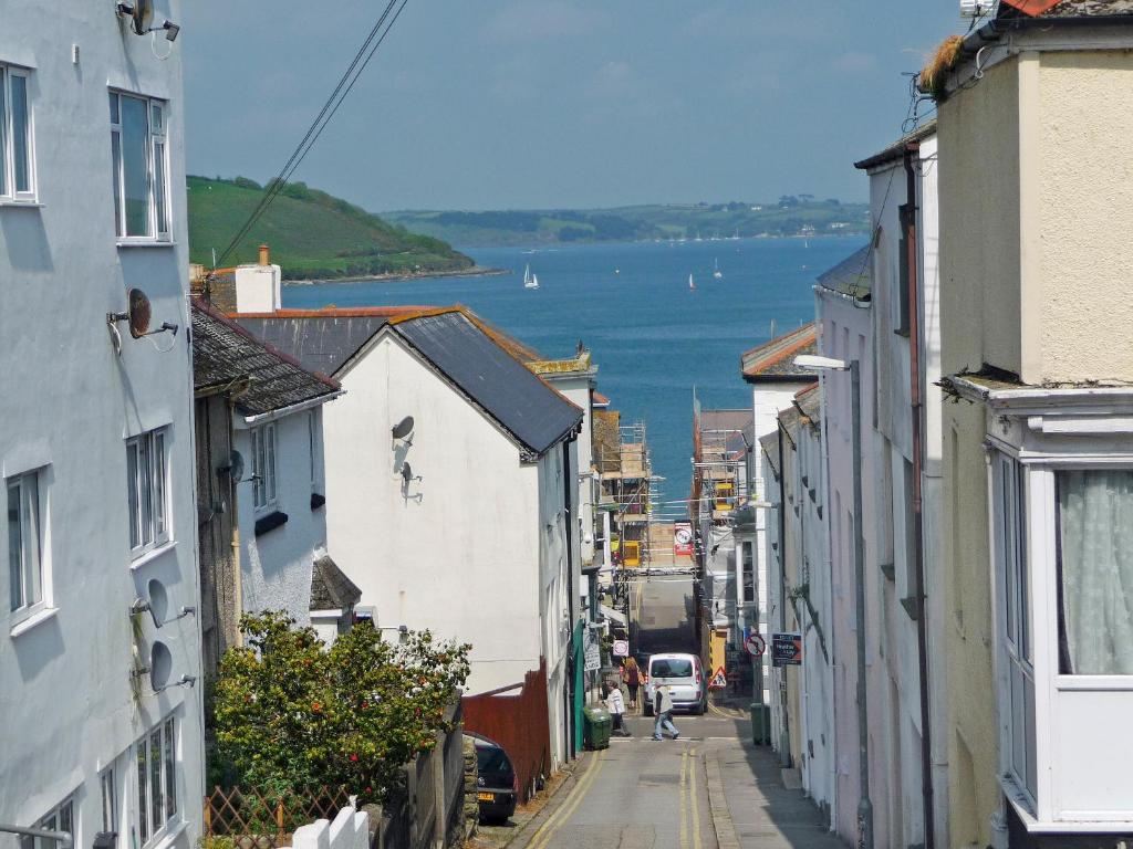 a city street with a view of a body of water at Roland Cottage in Falmouth