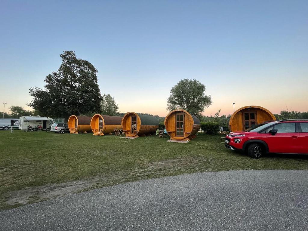 a group of circular wooden cabins in a field at Donaucamping Emmersdorf in Emmersdorf an der Donau
