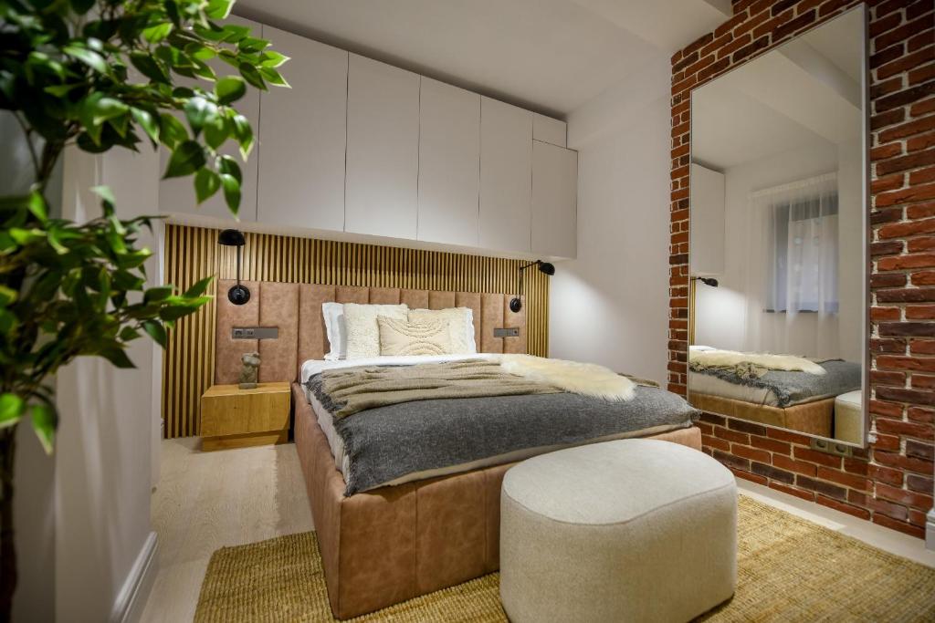 a bedroom with a large bed and a mirror at Modern Symphony - Stunning Central Apartment in Bucharest