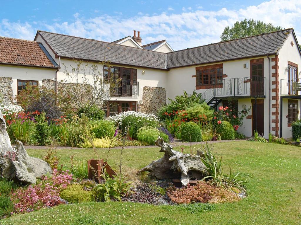 a house with a garden in front of it at The Carriages in Sidbury