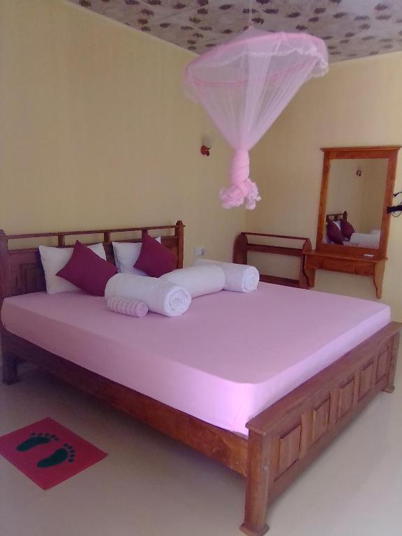 Postel nebo postele na pokoji v ubytování Jaye Homestay