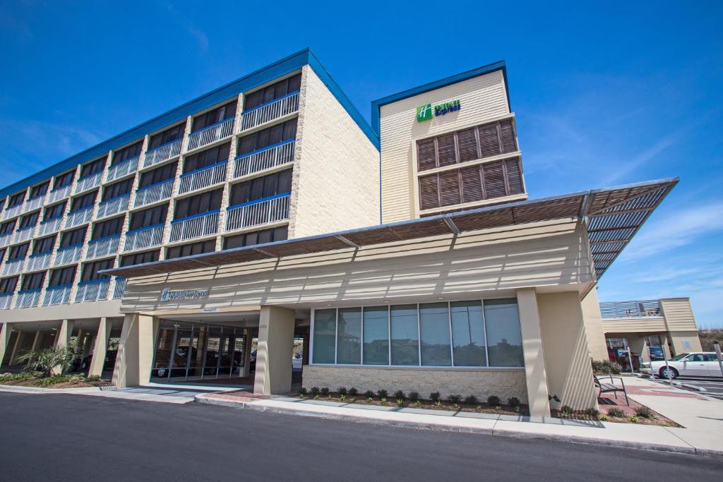 a hotel on a street with a building at Holiday Inn Express Nags Head Oceanfront by IHG in Nags Head