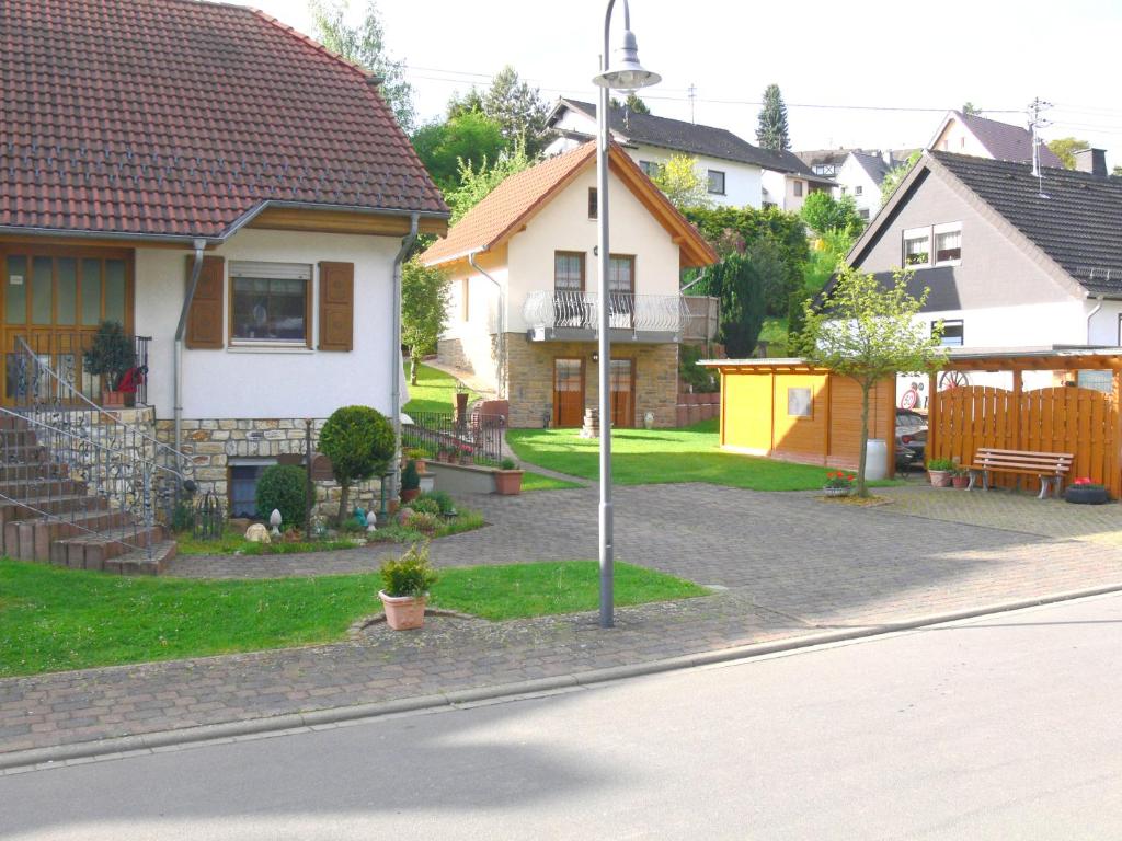 a house with a street light on the side of the road at Apartments Monika Schneider in Wimbach