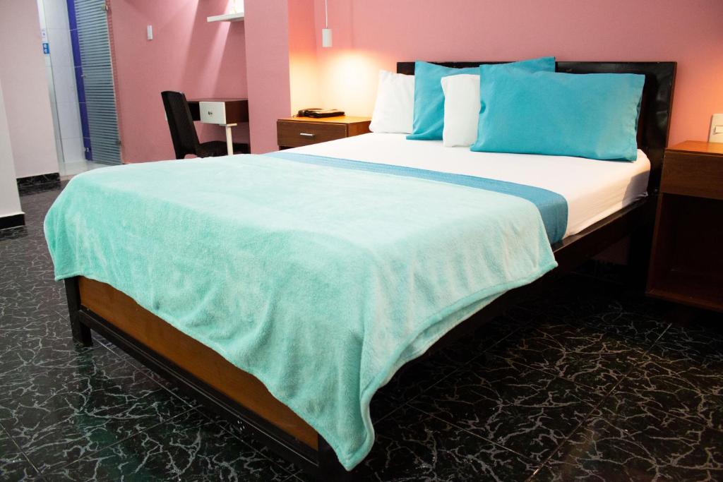 Postel nebo postele na pokoji v ubytování Hotel Brisas De Calima