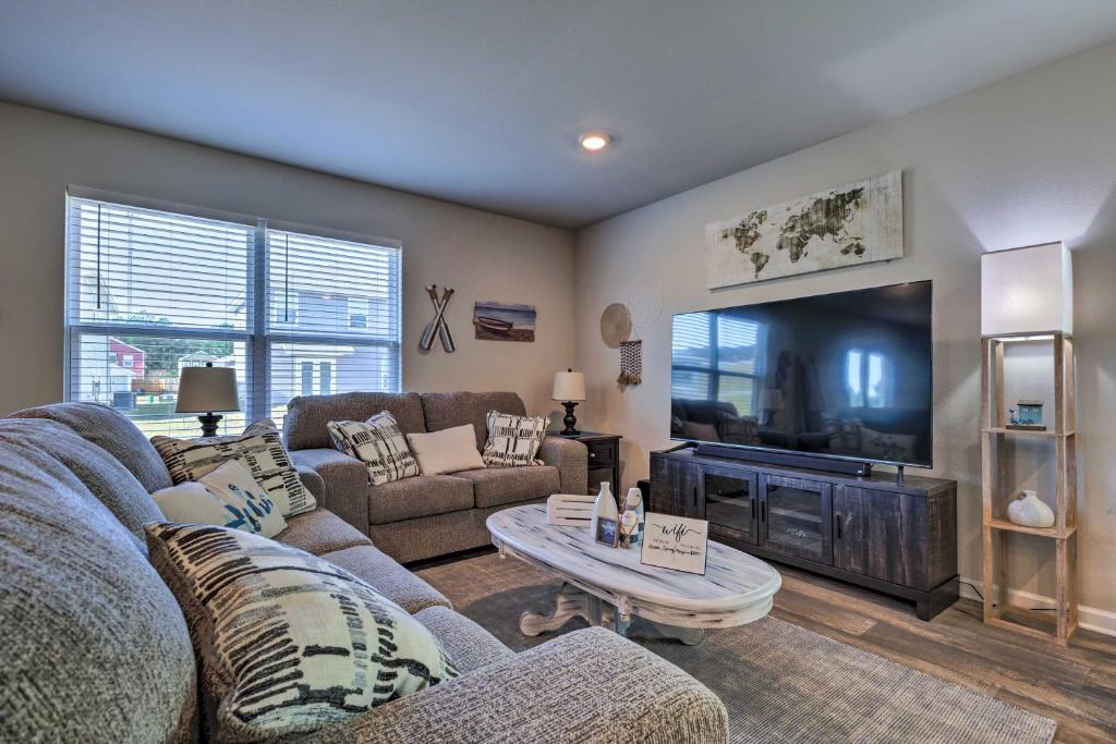 a living room with couches and a large television at Camden Ocean Springs House Near Beaches! in Ocean Springs