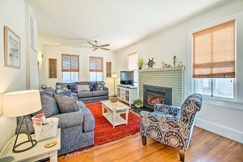 a living room with a couch and a fireplace at North Beach Cottage - Walk to Chesapeake Bay in North Beach