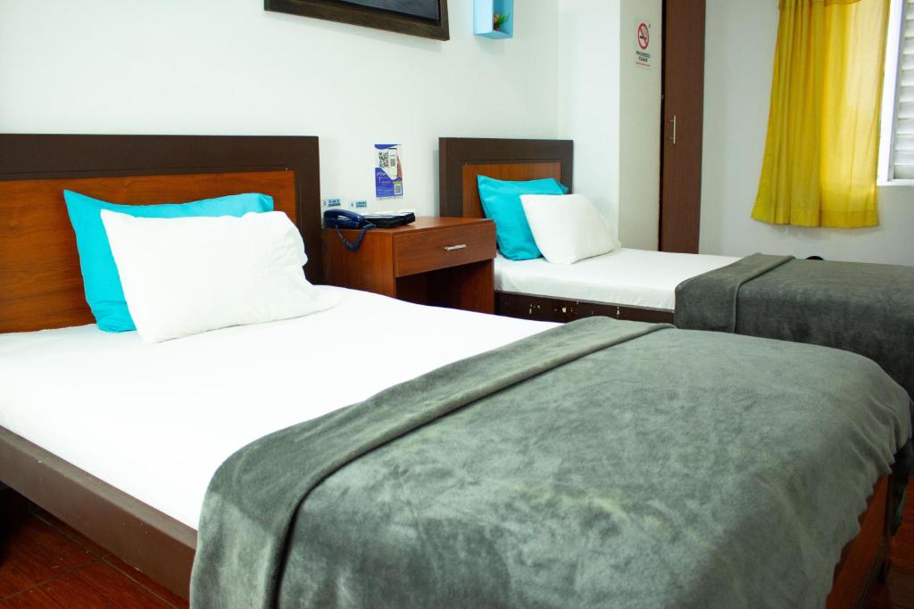 Postel nebo postele na pokoji v ubytování Hotel Brisas De Calima