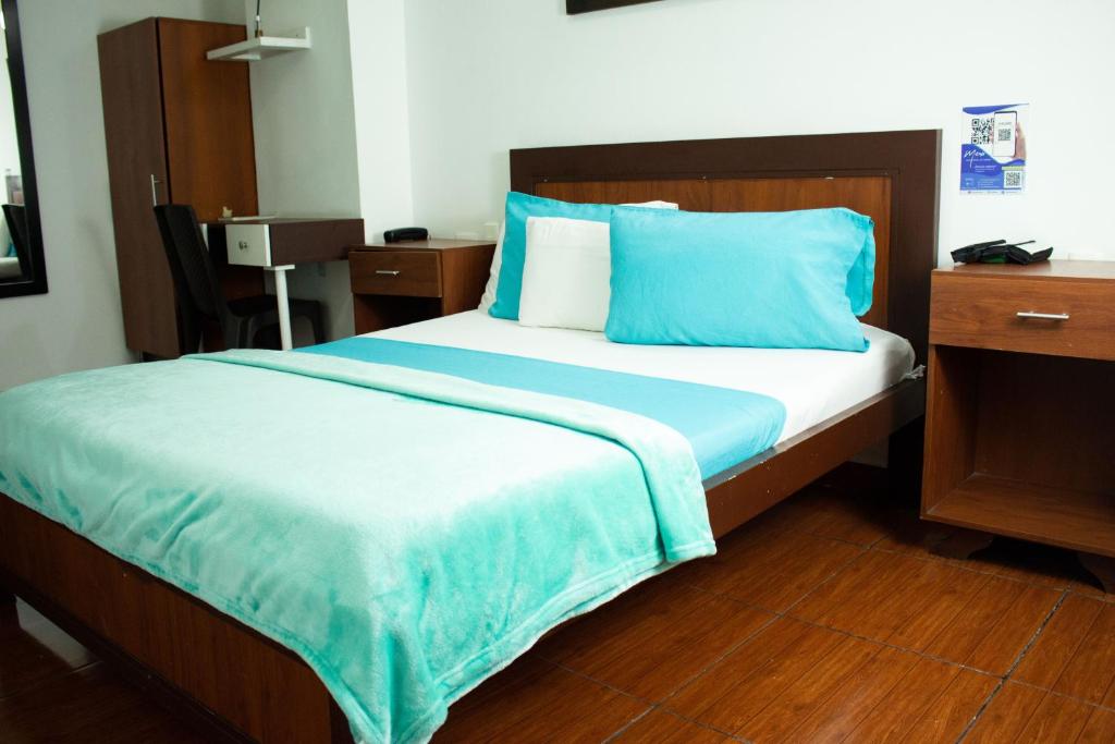 Postel nebo postele na pokoji v ubytování Hotel Brisas De Calima