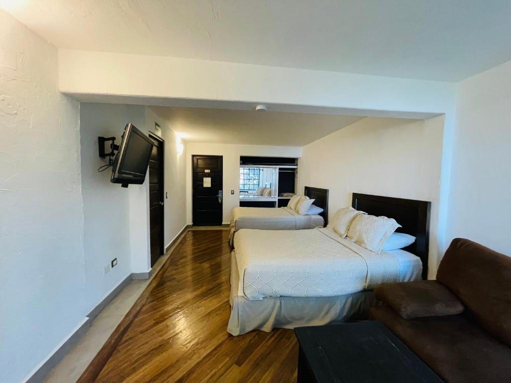Postel nebo postele na pokoji v ubytování Hotel Chipinque