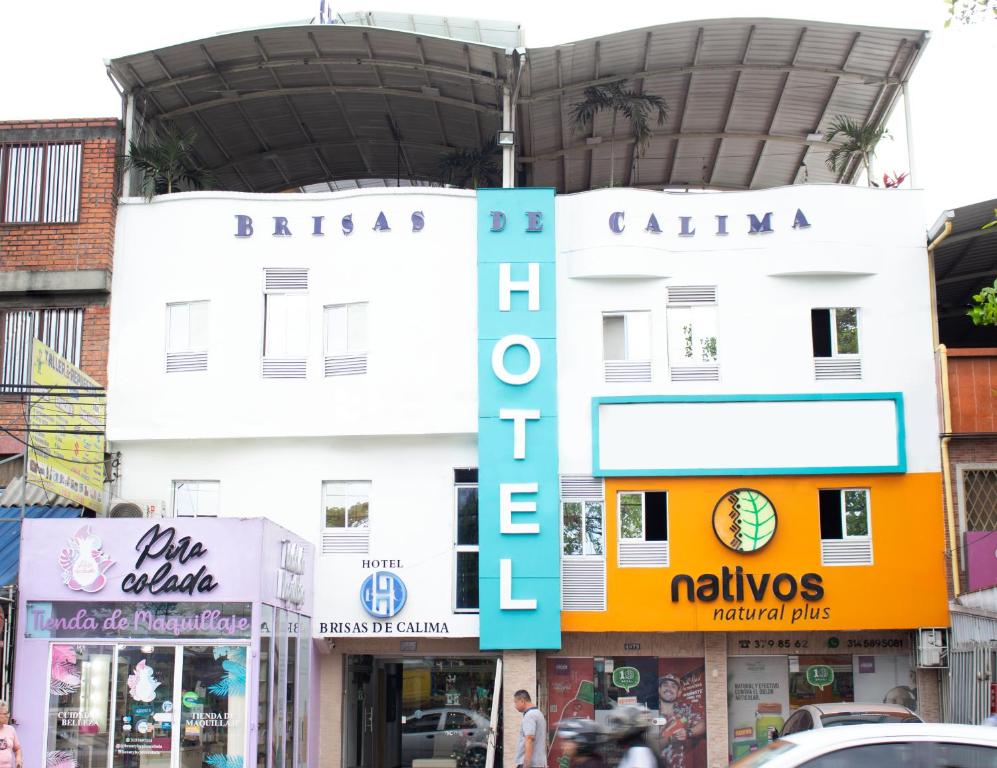 a building with a sign in the middle of a street at Hotel Brisas De Calima in Cali